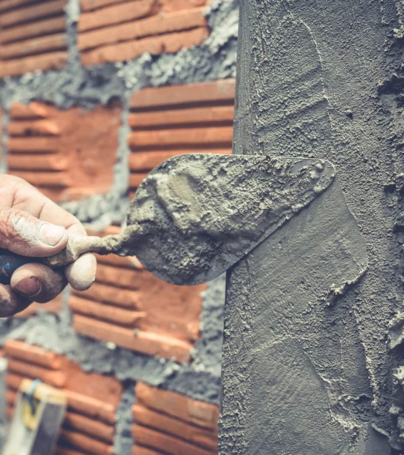 bricklaying-construction-worker-building-brick-wall-scaled